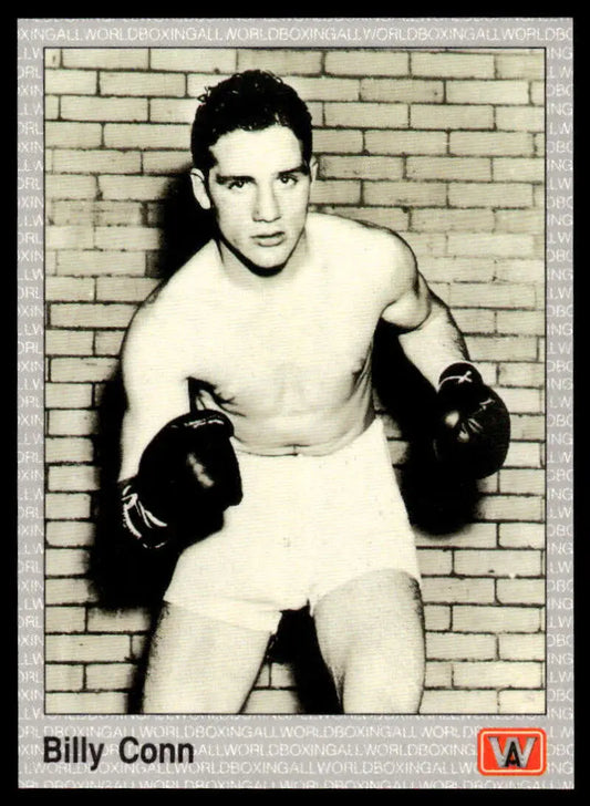 Shirtless boxer in fighting stance promoting Billy Conn NM-MT Boxing Card against brick wall