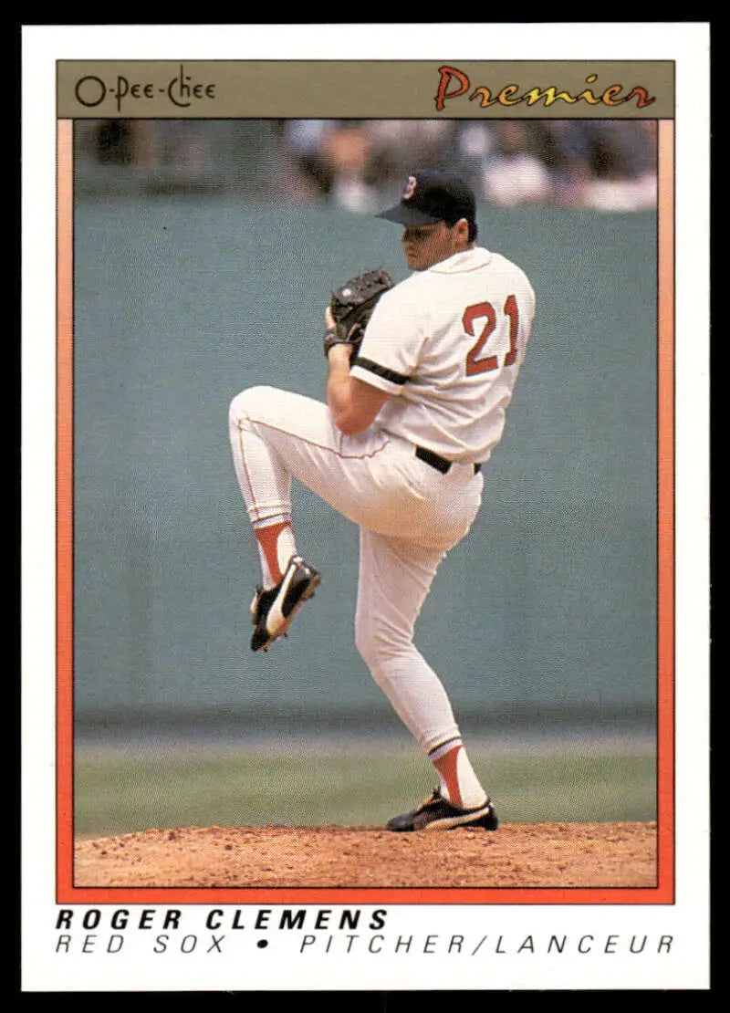 Baseball player in white uniform #21 pitching, featuring Roger Clemens of the Boston Red Sox