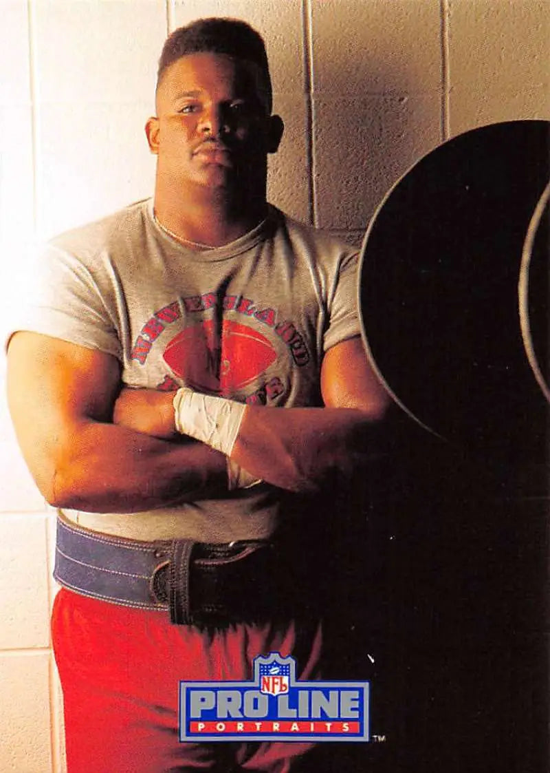 Ray Agnew posing in gray t-shirt and red shorts for Pro Line Portraits football card