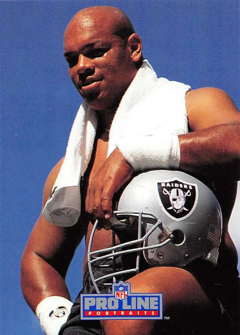 Greg Townsend holding an NFL Raiders helmet with a towel in Pro Line Portraits card