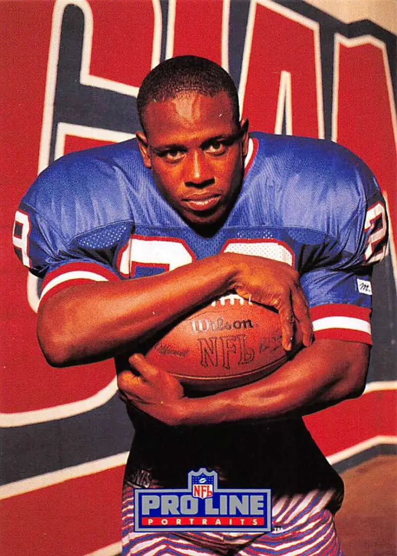 Myron Guyton in a blue jersey holding a Wilson NFL football for York Giants Pro Line Portraits