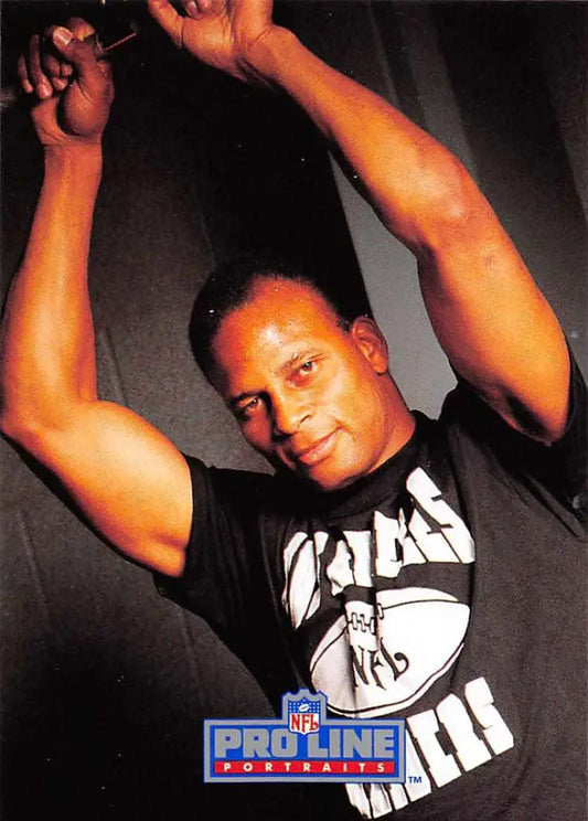 Promotional sports card of Ronnie Lott in a black and white tank top for Los Angeles Raiders