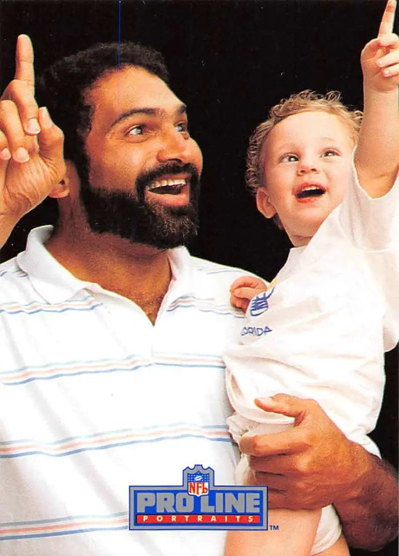 Bearded man in striped polo with child pointing, celebrating Franco Harris Pro Line Portraits