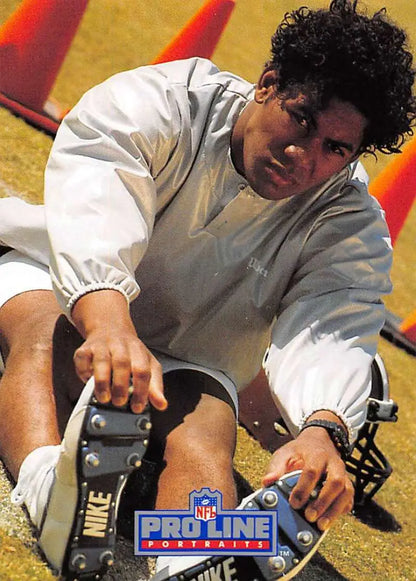 Football player stretching in training for Orleans Saints, featured in Pro Line Portraits card