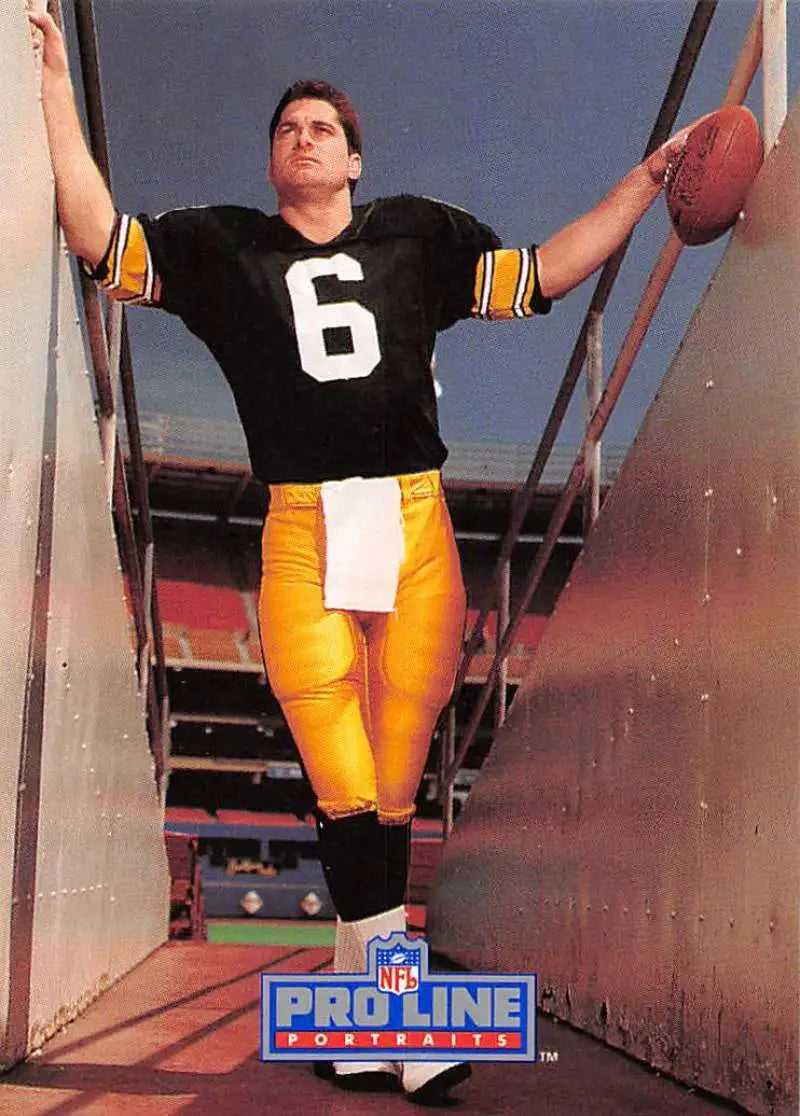 Bubby Brister in a black jersey with a football for 1991 Pro Line Portraits card