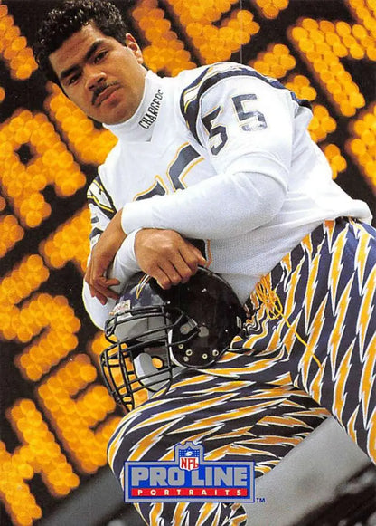 Junior Seau in white jersey 55 holding tiger-striped helmet on San Diego Chargers football card