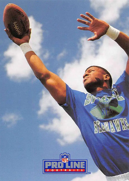 Football player in blue Seahawks jersey catching ball, featuring Brian Blades Pro Line Portraits