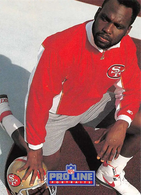 San Francisco 49ers football card featuring Guy McIntyre in a red team jacket