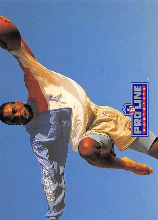 Martial artist performs high spinning kick under blue sky, Pro Line Portraits featuring Ernest Givins