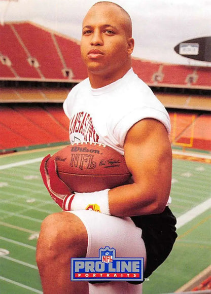 Barry Word in white sleeveless shirt holding football at Kansas City Chiefs stadium