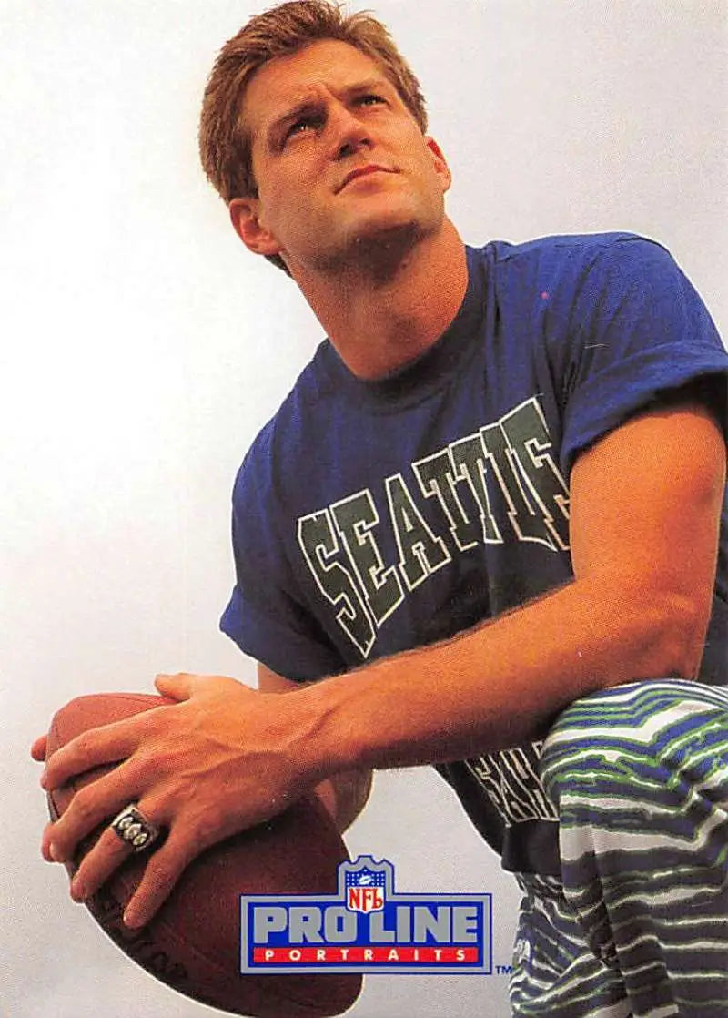 Person in blue Seattle t-shirt gazes up, celebrating Vann McElroy and Seattle Seahawks