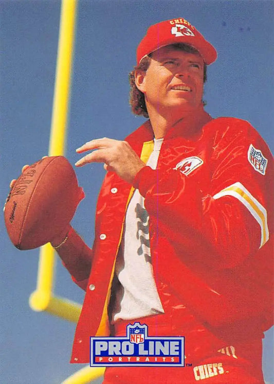 Kansas City Chiefs player Steve DeBerg in a red jacket holding a football