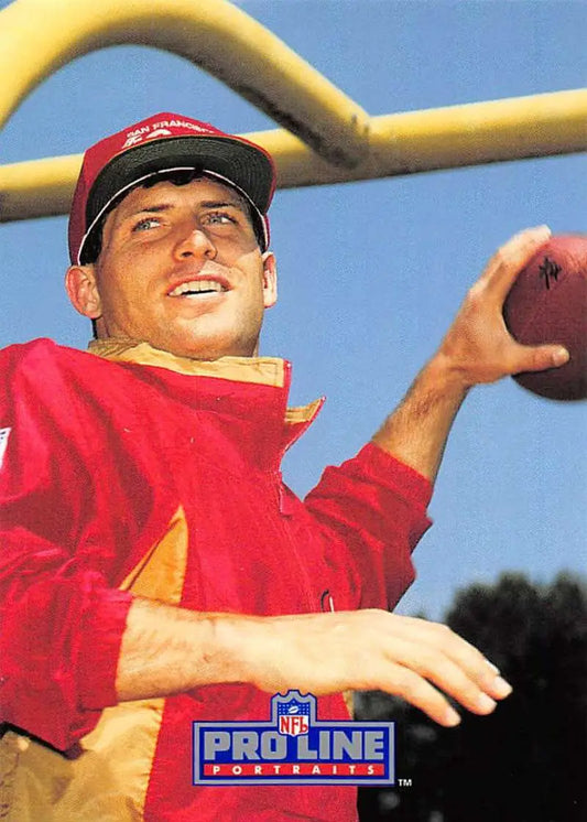 Football player in red jersey throwing football, showcasing Steve Young from Pro Line Portraits