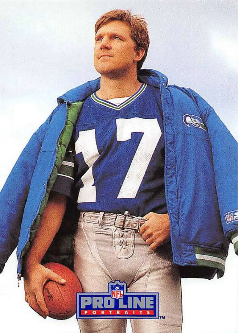 NFL player in number 17 jersey and blue Seahawks jacket holding football, featuring Dave Krieg