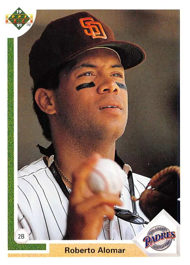 Baseball player Roberto Alomar in San Diego Padres uniform holding a baseball