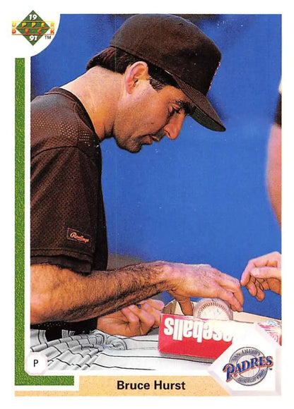 Baseball player Bruce Hurst in Padres uniform signing autograph for fans