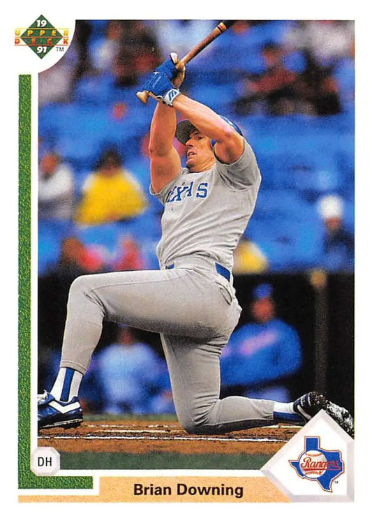 Baseball player Brian Downing in Texas Rangers uniform kneeling during a swing