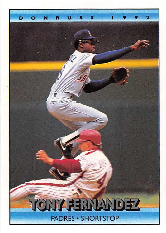 A baseball player leaps over a sliding baserunner in this Tony Fernandez NM-MT card