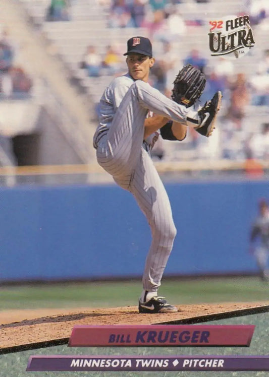 Baseball pitcher in delivery wearing Minnesota Twins uniform for Fleer Ultra Twins baseball card