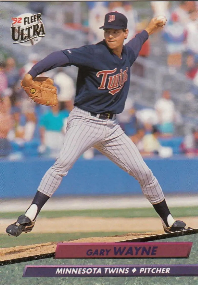 Minnesota Twins pitcher Gary Wayne mid-delivery in navy pinstriped uniform on mound