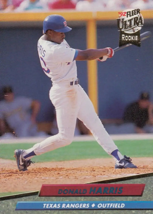 Donald Harris swinging a bat in a white Texas Rangers uniform on baseball card