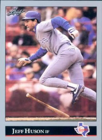 Baseball player Jeff Huson in gray Texas Rangers uniform jumps over a bat on field