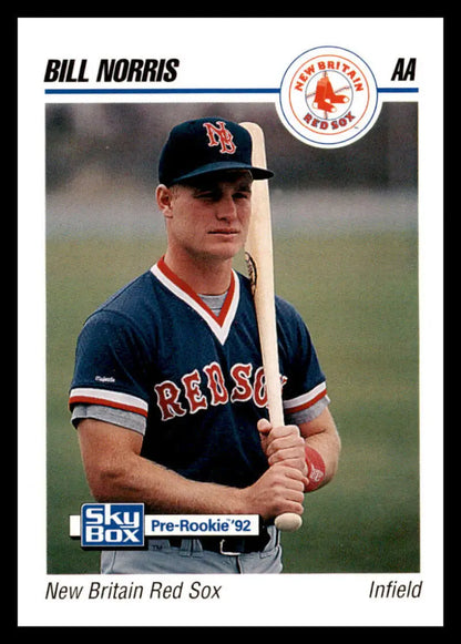 Baseball card of New Britain Red Sox infielder Bill Norris in navy uniform with bat