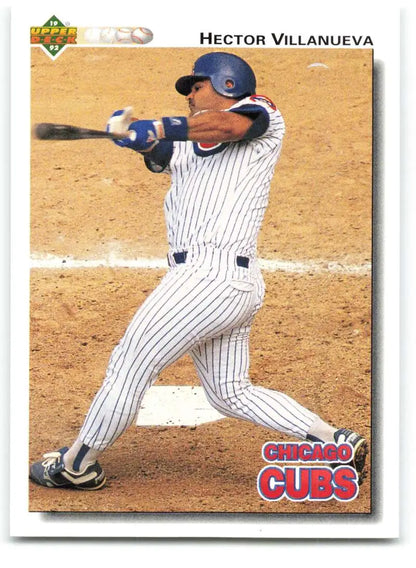 Hector Villanueva swinging bat in Chicago Cubs pinstripe uniform on baseball card