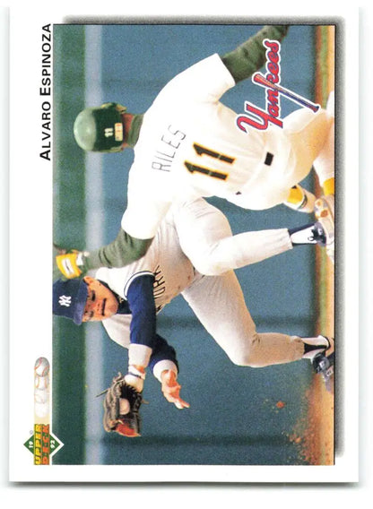 Baseball player Alvaro Espinoza sliding into base in Yankees uniform during game action