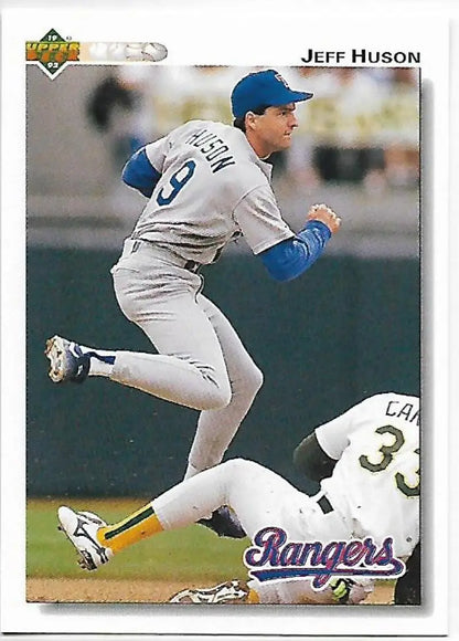 Jeff Huson leaps over a sliding opponent in Texas Rangers away uniform baseball card