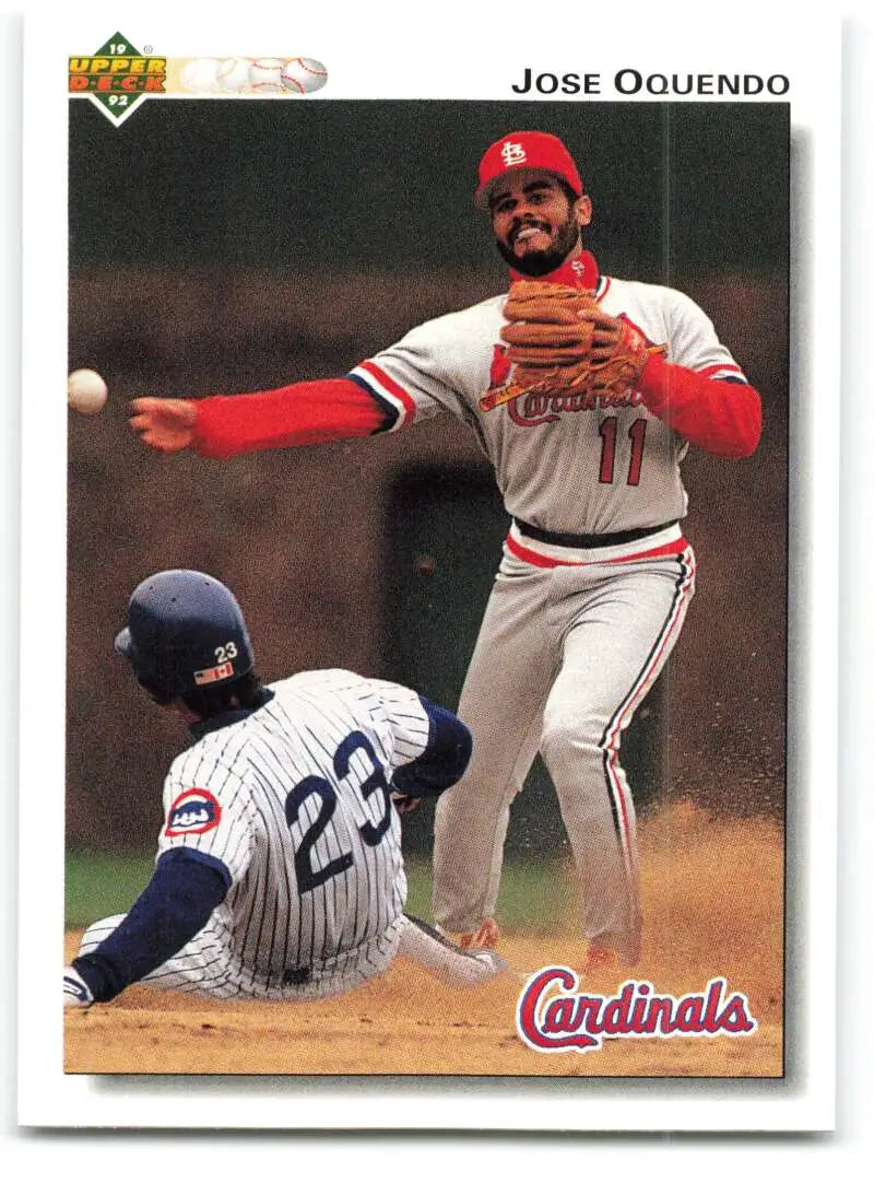 Jose Oquendo leaps over a sliding Yankees runner in this St. Louis Cardinals baseball card