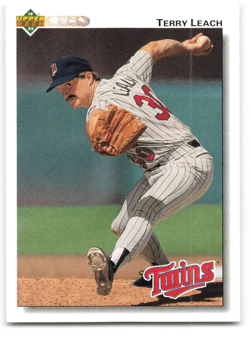 Terry Leach mid-delivery on a Minnesota Twins baseball card in pinstriped uniform