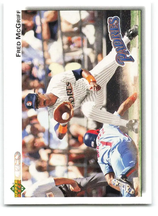 Baseball player Fred McGriff leaps to catch a ball in San Diego Padres uniform