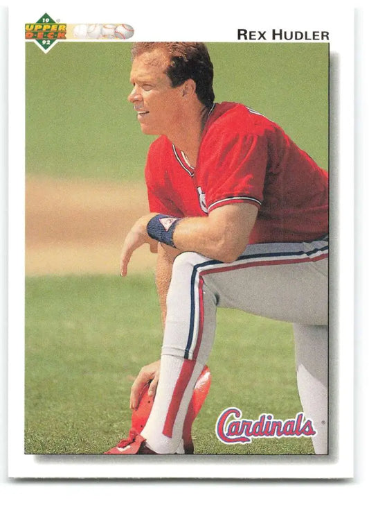 Rex Hudler in red and white Cardinals uniform sitting in dugout on Baseball Card