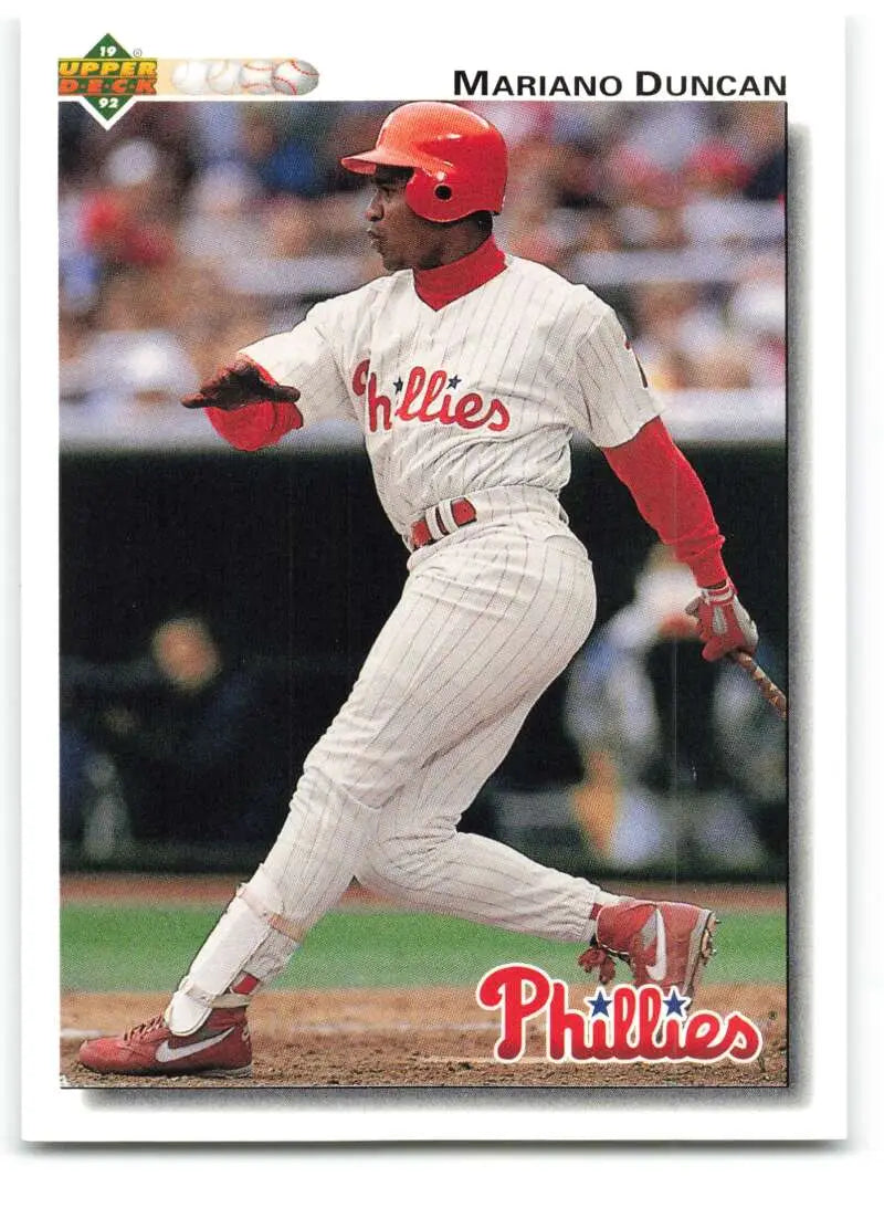 Mariano Duncan in white Phillies uniform executing a left-handed swing for Upper Deck card