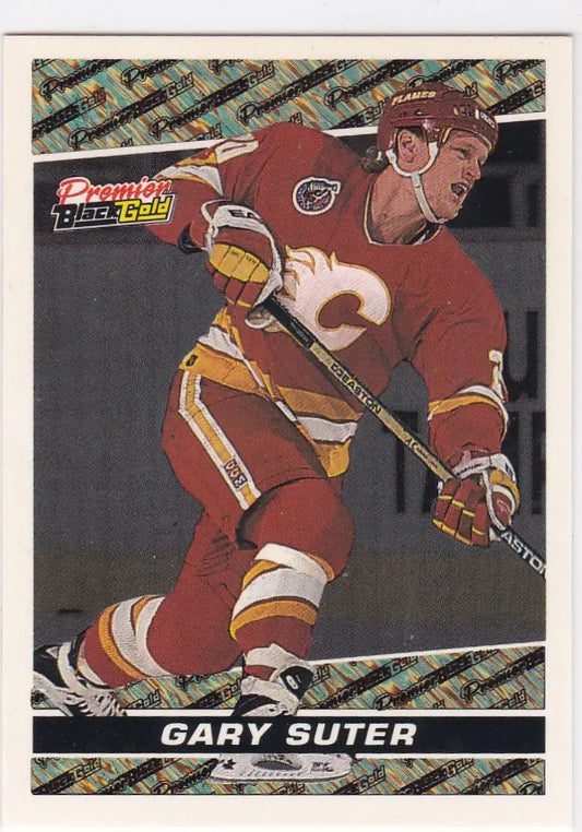 Hockey trading card of Gary Suter in red Calgary Flames uniform Topps Premiere Black Gold