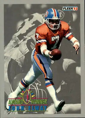 Denver Broncos football player John Elway in orange and blue uniform carrying the ball