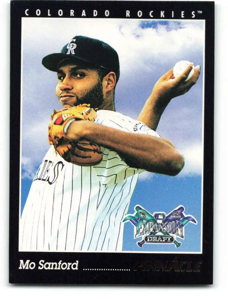 Baseball player in Colorado Rockies pinstriped uniform ready to pitch