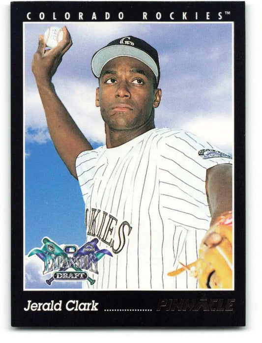 Jerald Clark in Colorado Rockies pinstriped uniform holding a baseball for baseball card