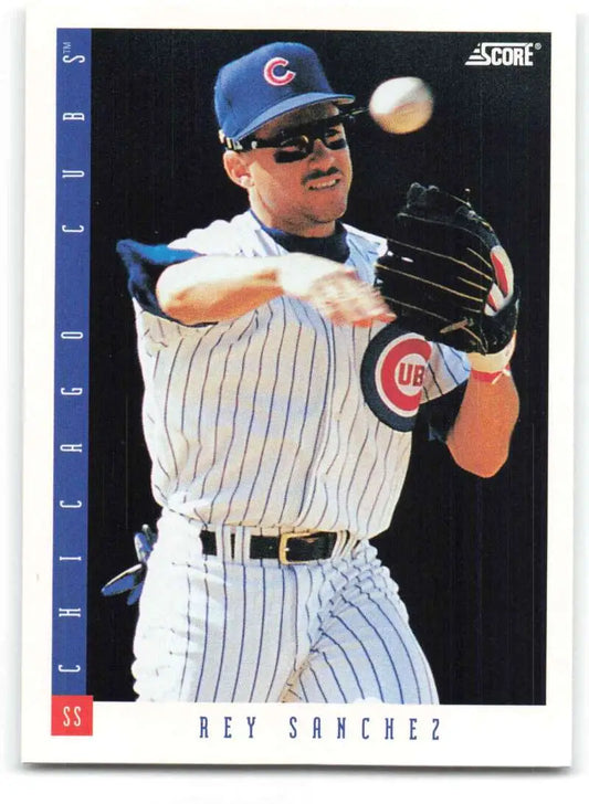 Rey Sanchez fields a baseball in his Chicago Cubs pinstriped uniform on this card