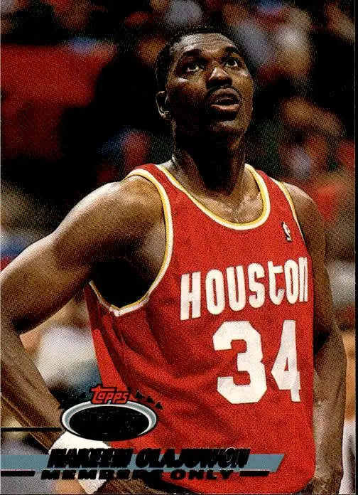 Basketball player in red Houston Rockets jersey number 34 for 1993 Stadium Club Hakeem Olajuwon