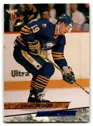 Hockey player in dark blue and yellow Buffalo Sabres uniform skating with stick, Randy Wood Buffalo