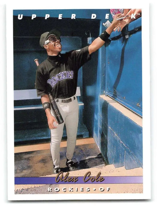 A baseball card of Alex Cole from the Colorado Rockies in the dugout reaching upward