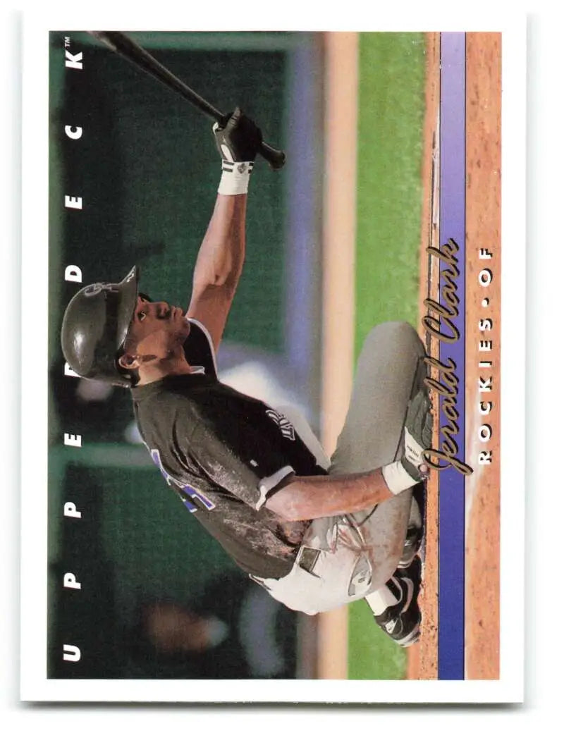 Jerald Clark in dark uniform swinging bat on Colorado Rockies baseball card