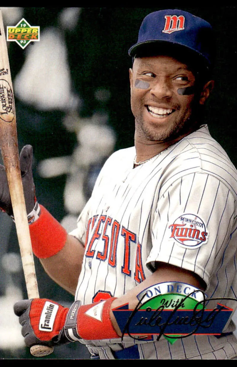 Minnesota Twins player Kirby Puckett in pinstriped uniform smiling with a bat