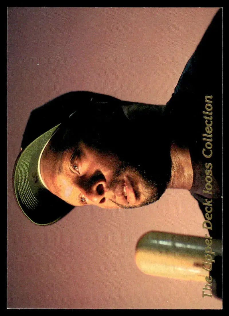 Person in dark baseball cap with soft-lit backdrop featuring Kirby Puckett Upper Deck card