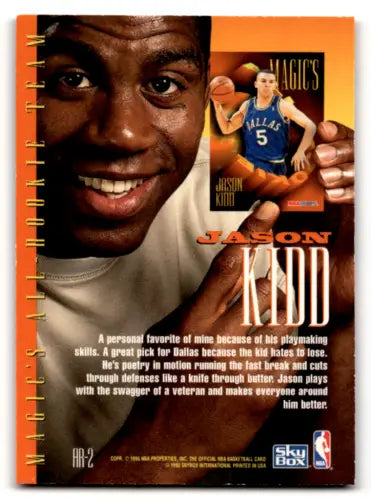 Magic Johnson holds a Jason Kidd basketball card from 1994-95 Hoops original gloss