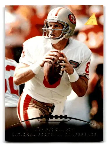 Football player in uniform holding ball, featuring original gloss of Steve Young, 49ers