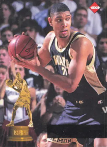 Basketball player showcasing Tim Duncan Wake Forest rookie card with ball