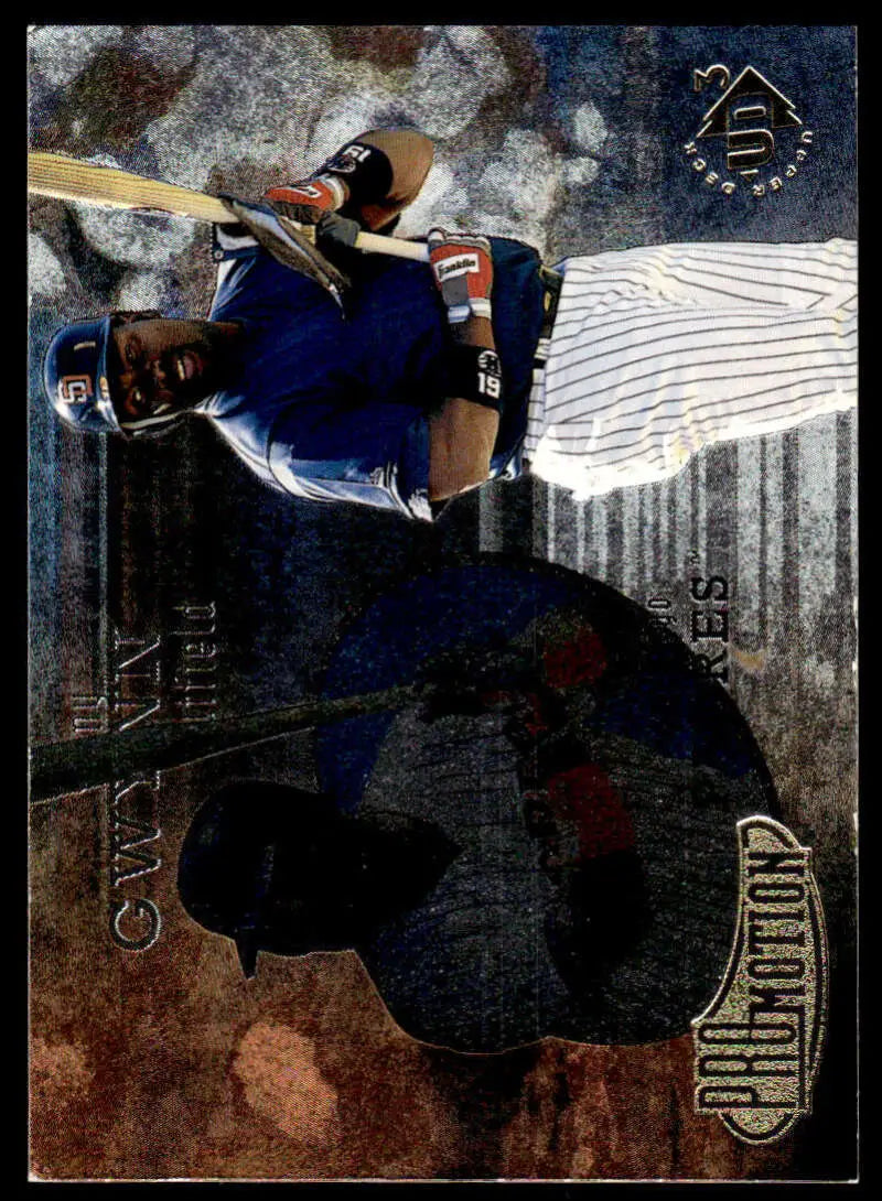 Baseball player Tony Gwynn in blue and white pinstriped uniform swinging bat on card